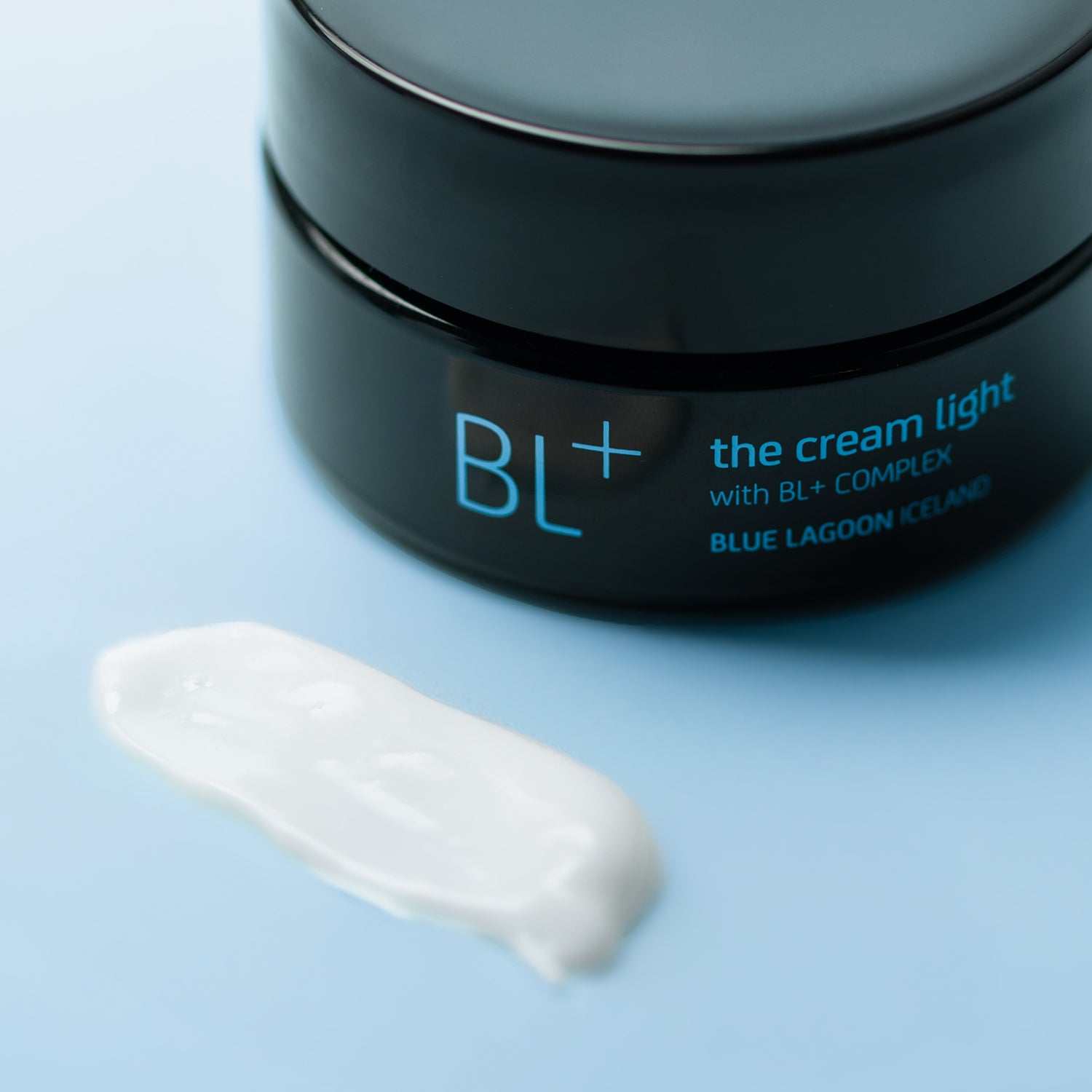 BL+ The Cream Light jar with cream texture on a light blue surface