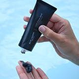 Model dispensing Lava Scrub Mask into hand from tube