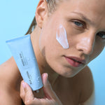 Model with Mineral Mask applied to cheek holding tube