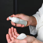 Model holding Foaming Cleanser foam in open palm