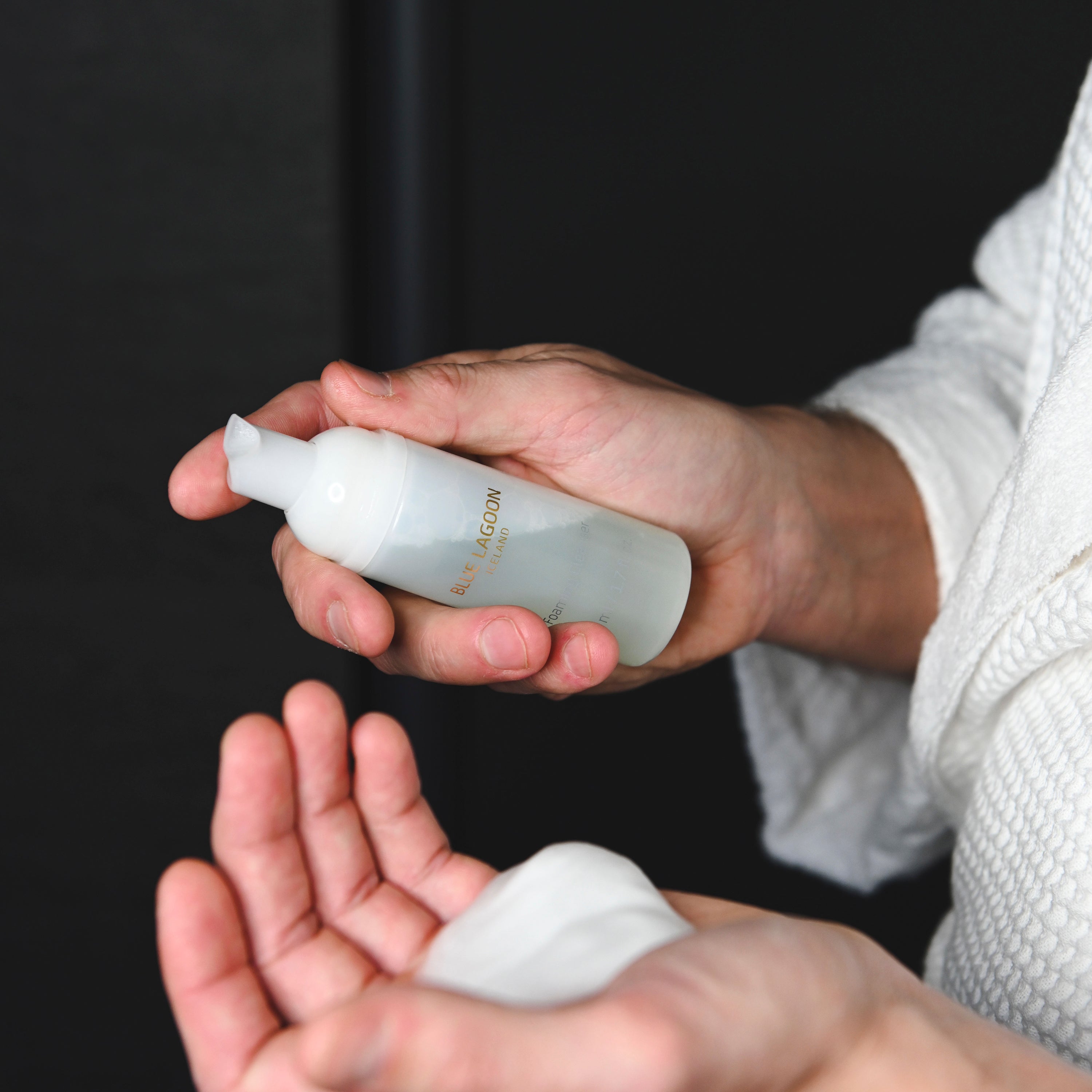 Model holding Foaming Cleanser foam in open palm