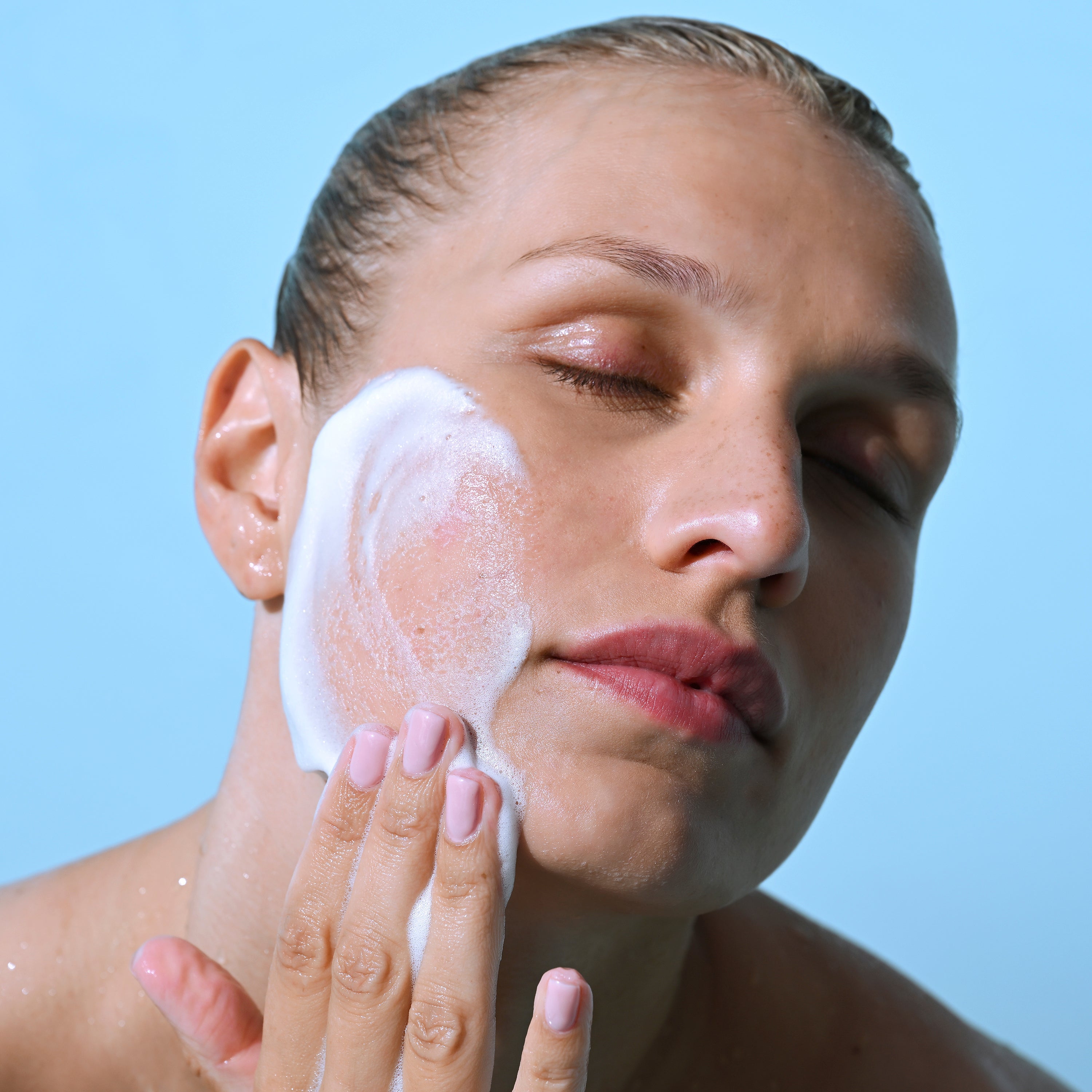 Model massaging Foaming Cleanser foam onto face