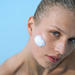 Model applying Foaming Cleanser foam to cheek