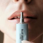 Model applying Lip Balm from tube to lips