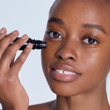 Model applying BL+ The Eye Serum under eyes