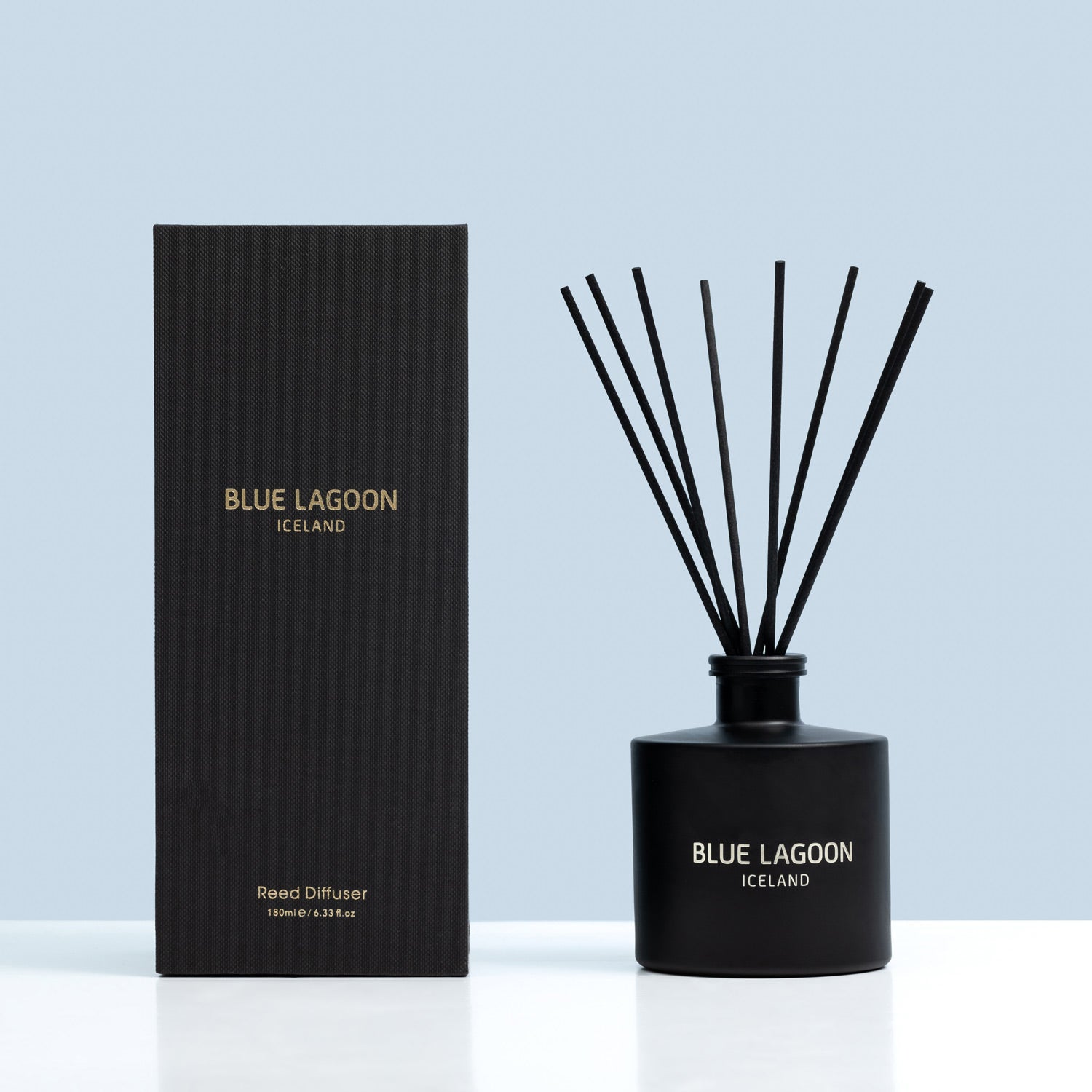 Reed Diffuser bottle with the product box on blue background