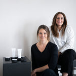 Women sitting next to Mirrored Mask Stand and Silica Mud Mask